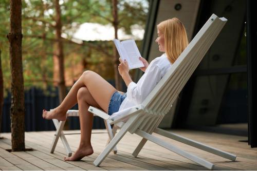 Girl reading a book on a bench 