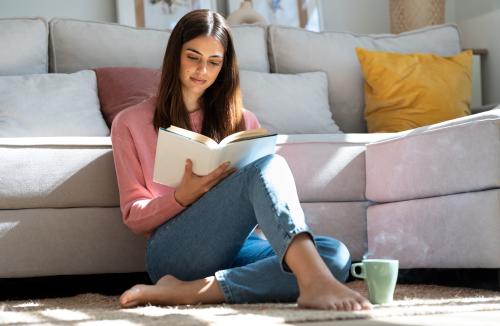 Person reading a book on the floor 