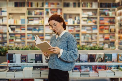 Girl reading a book in the library 