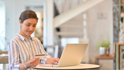 Person using the laptop to make payment for PSW visa in UK